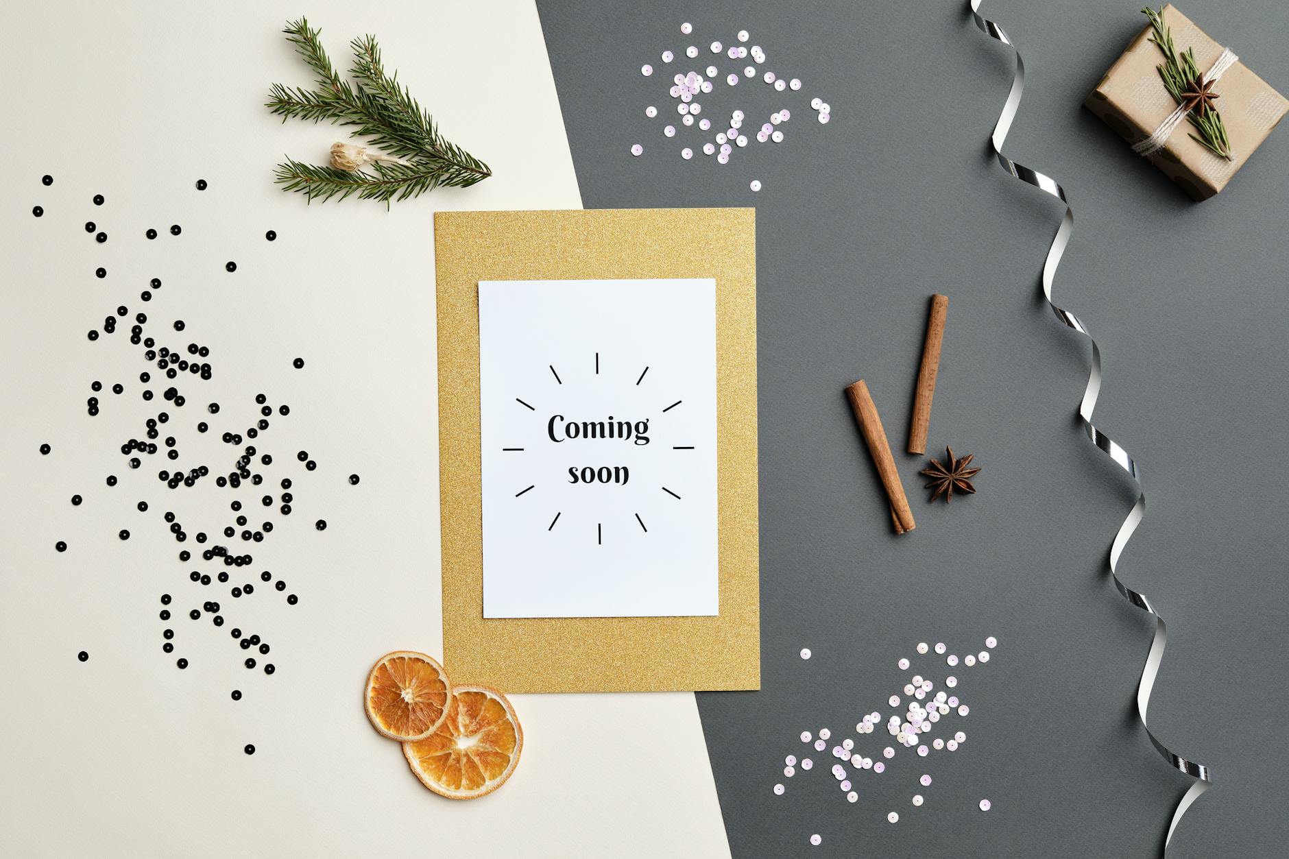 greeting card lying on table surrounded by dried orange slices and sticks of cinnamon